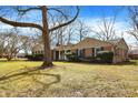 Well-maintained brick ranch with mature trees and landscaping in a quiet neighborhood at 5785 Susan E Dr, Indianapolis, IN 46250