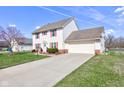 Charming two-story home with an attached garage and a long driveway at 6843 Long Run Dr, Indianapolis, IN 46268