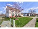 Charming two-story home with red shutters, beautiful trees and a well-manicured lawn at 6843 Long Run Dr, Indianapolis, IN 46268