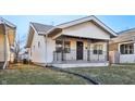 Quaint one-story home featuring a cozy front porch and manicured lawn at 741 N Linwood Ave, Indianapolis, IN 46201