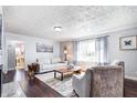 Cozy living room featuring comfortable seating, hardwood floors, and lots of natural light at 7816 E St Joseph St, Indianapolis, IN 46219