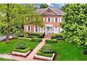 Traditional brick home with white shutters, manicured landscaping, and brick walkway at 8015 Heyward Dr, Indianapolis, IN 46250