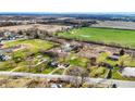 An aerial perspective of the property featuring serene ponds, walking paths, and scattered residences at 905 S Maple St, Fortville, IN 46040