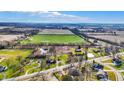 Overhead image highlighting the property's layout with ponds, mature trees, and the adjacent farmland at 905 S Maple St, Fortville, IN 46040
