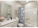 Bright bathroom with white vanity, quartz countertop, blue patterned shower curtain, and decorative accents at 9709 Tampico Chase, Fishers, IN 46040