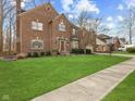 Charming two-story brick home with a well-manicured lawn, lush green grass, and walkway at 10145 Northwind Dr, Indianapolis, IN 46256