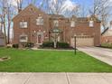 Beautiful brick two-story home with a well-manicured lawn and attached two car garage at 10145 Northwind Dr, Indianapolis, IN 46256