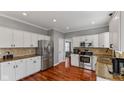Bright kitchen featuring white cabinets, stainless steel appliances, and granite countertops at 10145 Northwind Dr, Indianapolis, IN 46256