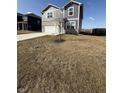 Two story home boasts vinyl siding, stone accents, two car garage, and a long concrete driveway at 10950 N Heirloom Dr, Monrovia, IN 46157