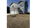 Two story home boasts vinyl siding, stone accents, two car garage, and a long concrete driveway at 10950 N Heirloom Dr, Monrovia, IN 46157