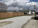 Gravel backyard with a new wooden fence between properties at 117 N 10Th St, Elwood, IN 46036