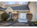 Home's entryway featuring a double door and manicured shrubs at 12348 Seaway Cir, Indianapolis, IN 46236