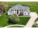 Aerial view of a stately two-story home featuring a well-manicured lawn and a basketball court at 1358 Rutherglen Ct, Danville, IN 46122