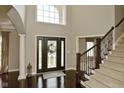 Elegant foyer with hardwood floors, large window, and staircase showcasing the home's grand entrance at 1358 Rutherglen Ct, Danville, IN 46122