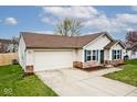 Well-maintained home featuring a 2-car garage, vinyl siding, brick accents, and a green lawn at 1378 Millridge Dr, Greenwood, IN 46143
