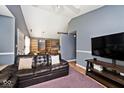Comfortable living room featuring vaulted ceilings, a large couch, hardwood floors and plenty of natural light at 1378 Millridge Dr, Greenwood, IN 46143