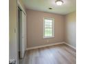 Bedroom features include a large window, light-colored walls, and wood-look flooring at 1509 E Centennial Ave, Muncie, IN 47303