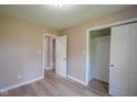 This neutral bedroom has light walls, wood-look flooring and a roomy closet at 1509 E Centennial Ave, Muncie, IN 47303