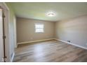 Bedroom featuring a large window, neutral color scheme, and wood-look flooring at 1509 E Centennial Ave, Muncie, IN 47303