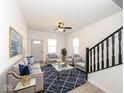 Bright living room featuring modern furniture, wood floors, and a decorative ceiling fan at 1521 Lawton Ave, Indianapolis, IN 46203