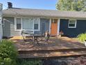 Cozy front deck featuring outdoor seating, string lights, planters, and a stylish orange front door at 15415 E 146Th St, Noblesville, IN 46060