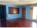 Living room featuring wood floors, light blue walls, window and interior door at 224 Griffin Rd, Indianapolis, IN 46227