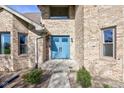 Charming blue double-door front entry with well-manicured landscaping at 2274 W Huntsville Rd, Pendleton, IN 46064