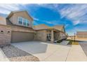 Spacious home featuring a large driveway leading to a two-car garage and a charming covered front porch at 2326 Saddle Dr, Shelbyville, IN 46176