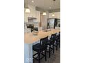 Bright kitchen boasts a large center island with seating, stainless steel appliances, and pendant lighting at 2882 Simsbury Ln, Brownsburg, IN 46112
