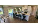 Open-concept kitchen with island seating flows into the living area and features stainless steel appliances at 2882 Simsbury Ln, Brownsburg, IN 46112
