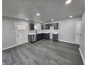 Well-lit kitchen with gray cabinets, stainless steel appliances, and stylish laminate flooring at 3262 Orchard Ave, Indianapolis, IN 46218