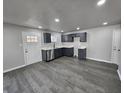 Well-lit kitchen with gray cabinets, stainless steel appliances, and stylish laminate flooring at 3262 Orchard Ave, Indianapolis, IN 46218