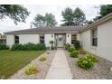 Well-maintained single story home with attractive landscaping and a welcoming walkway to the front door at 3335 Woodcrest Ct, Columbus, IN 47203