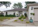 Charming single-story home with a well-manicured lawn, rock garden, and decorative accents at 3335 Woodcrest Ct, Columbus, IN 47203