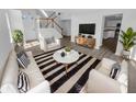 Bright living room with hardwood floors, stylish furniture, and lots of natural light at 4047 Orchard Valley Ln, Indianapolis, IN 46235