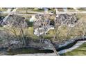 Aerial view of a home with beautiful landscaping, a creek, and a small bridge at 4140 Sagewood Ct, Greenwood, IN 46143