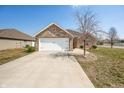 Lovely home with a brick facade, double garage door, concrete driveway, and manicured lawn at 4347 Westminster Pl, Columbus, IN 47201