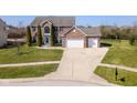 Expansive two-story brick home with manicured lawn, mature trees, and long driveway at 5852 Sunnyvalle Dr, Bargersville, IN 46106