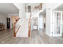 Elegant foyer with a soaring ceiling, wood floors, staircase, and natural light at 5852 Sunnyvalle Dr, Bargersville, IN 46106