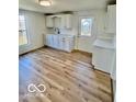 Efficient kitchen with white cabinets, updated countertops, and new vinyl flooring at 607 S Pleasant St, Edinburgh, IN 46124