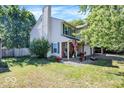 Well-maintained home with a brick-accented facade, green shutters, and a beautiful lawn at 6119 Denise Dr, Indianapolis, IN 46221