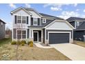 Two-story home featuring gray siding, black shutters, well-manicured lawn, and a two-car garage at 6724 Seattle Slew Dr, Whitestown, IN 46075