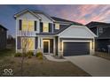 Charming two-story home featuring gray siding, black shutters, and a two-car garage at 6724 Seattle Slew Dr, Whitestown, IN 46075