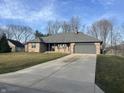 Beautiful single-story home featuring an attached garage and long driveway at 7020 Bloomfield Dr, Indianapolis, IN 46259