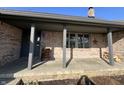 Covered front porch featuring brick columns and concrete floor at 7020 Bloomfield Dr, Indianapolis, IN 46259