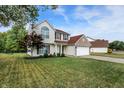 Attractive home with manicured lawn and mature trees creating nice curb appeal at 712 Burr Oak Dr, Greenwood, IN 46143