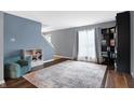 Cozy living room with hardwood floors, a large area rug, and neutral paint at 712 Burr Oak Dr, Greenwood, IN 46143