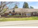 Charming brick home with a covered porch and well-maintained landscaping at 7943 Beaumont Green East Dr, Indianapolis, IN 46250