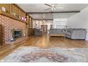 Inviting living room featuring wood floors, brick fireplace, and comfortable seating at 847 Churchman Ave, Beech Grove, IN 46107