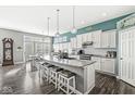 Spacious kitchen with a large island, modern appliances, and stylish pendant lighting at 8759 Buttonbush Cir, Plainfield, IN 46168